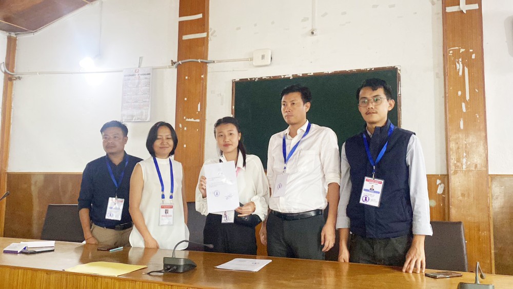 Nzanrhoni I Mozhui, 22 years old Nagaland youngest elected member of ULB Election 2024 from Bhandari Town Council Ward 1 BJP receiving her certificate from the Observer, Returning Officer, Assistant Returning Officer, and Border Magistrate at DC Conference Hall Wokha on June 29. (Morung Photo)